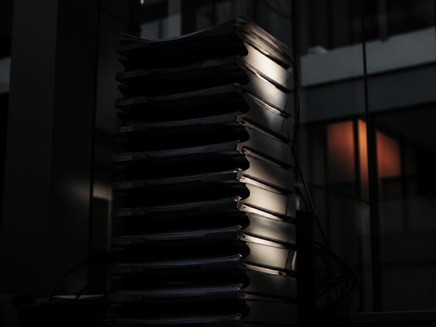 Stacked trays and coiled cables forming an abstract pattern of operational complexity